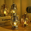 A set of brass-colored LED lanterns with warm glow, displayed on a wooden surface.