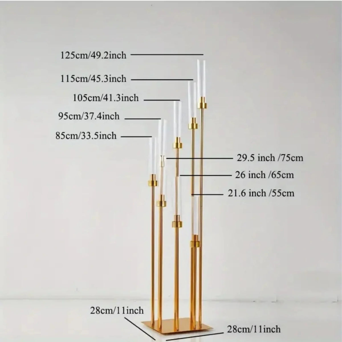 A set of elegant gold metal candle holders displayed vertically with various heights and sizes.