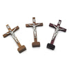 Handcrafted wooden crucifix with a cross and figure mounted on a wooden stand