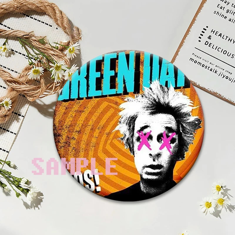 A circular button pin featuring a stylized face with pink Xs against an orange background, related to a punk band album cover