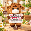 A handcrafted crochet cow doll with fluffy white horns and brown body, featuring a thank you message tag.