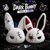 A pair of white bunny plush keychains with distressed features and red accents against a dark background.
