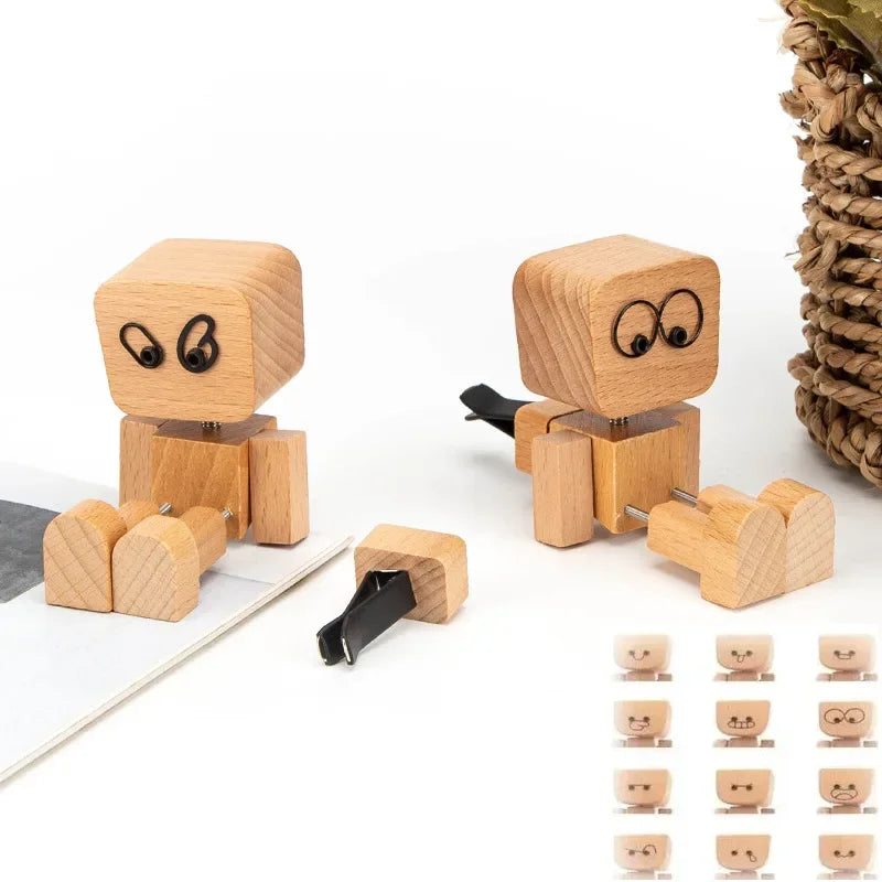 A set of wooden man figurines with swinging arms and a small car, used as desk decoration.