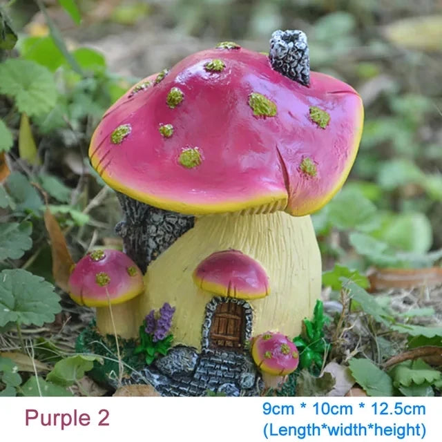 A small resin garden statue of a mushroom house with pink and yellow accents growing in natural foliage.