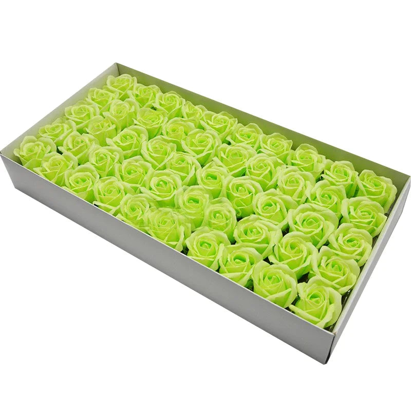 A rectangular box filled with numerous bright lime green artificial rose heads for decoration.
