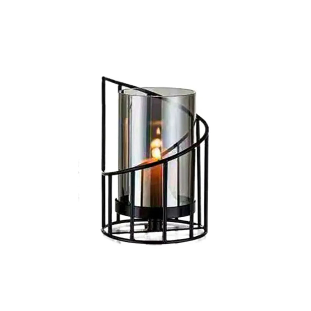 Elegant metal and glass candle holder with a flickering flame inside.