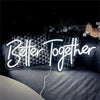 A glowing neon sign spelling out Better Together is displayed on a dark surface.