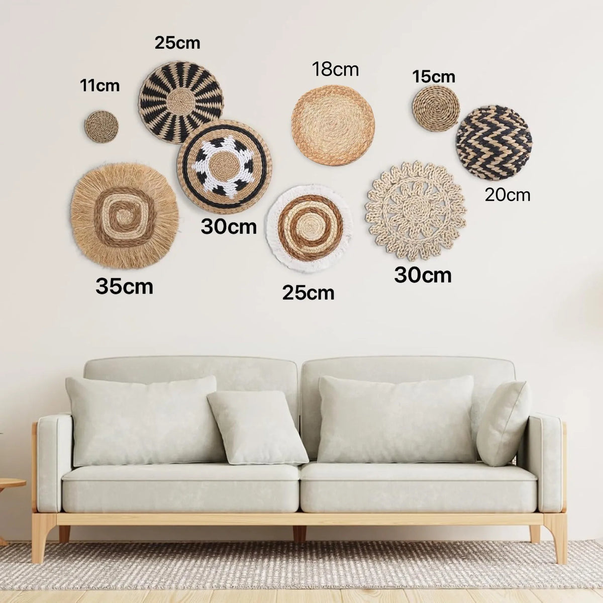 A collection of round boho straw wall hangings with varying sizes and textures displayed on a white wall.