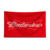 A red fabric flag featuring white text spelling out Budweiser across a diagonal white line.