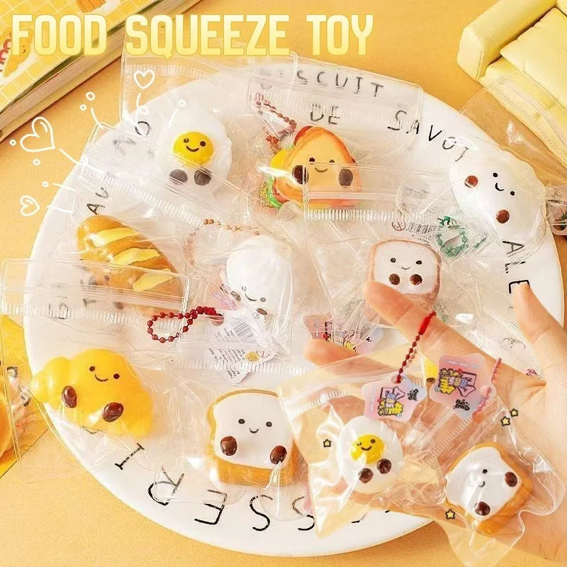 A collection of cute cartoon food squeeze toys and keychains on a white plate.