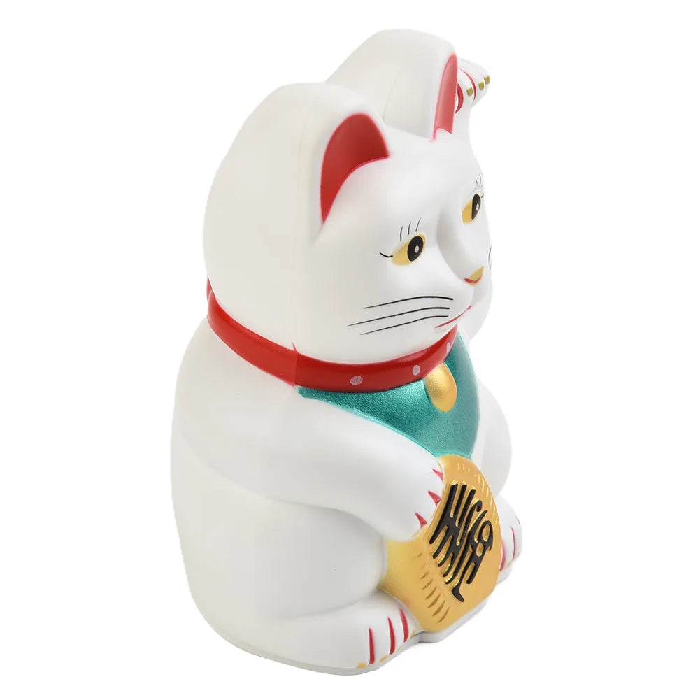 A white ceramic figurine of a cat wearing a red collar and holding a gold fortune coin.