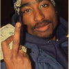 A close-up photo of a man wearing a patterned bandana and a dark jacket, holding a piece of paper with his finger.