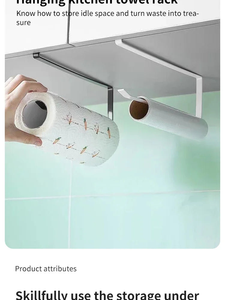 A hand is holding a roll of paper towel with decorative designs, demonstrating the storage solution for kitchen or bathroom s