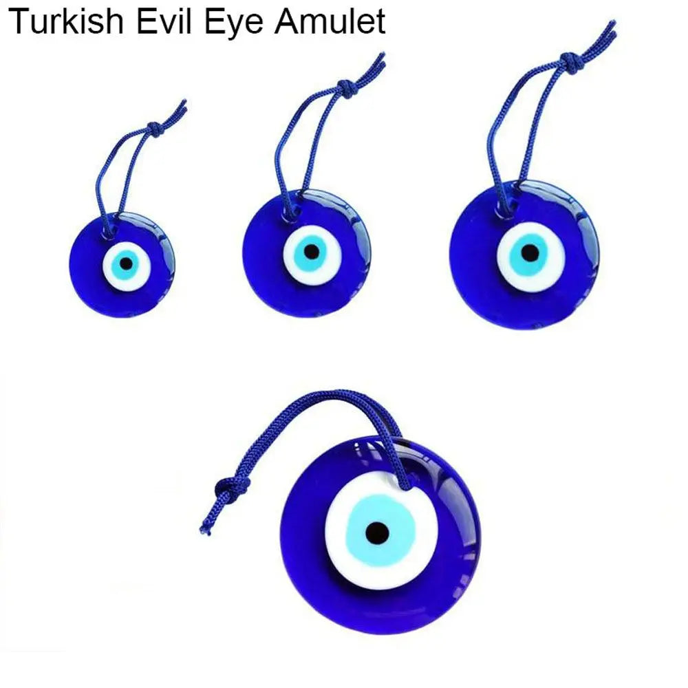 A collection of blue glass evil eye amulets or pendants with white and black irises on thin strings.