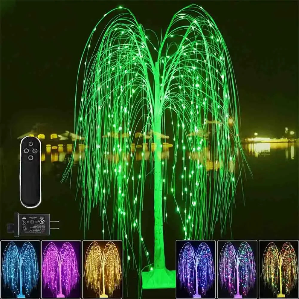 A large weeping willow tree light display with green LED strands illuminating a dark night scene.