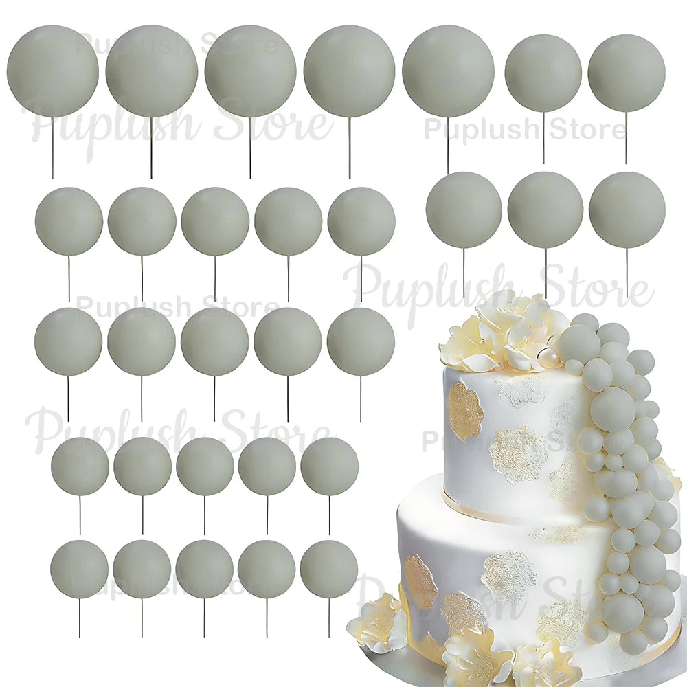 A set of white and light gray foam cake toppers on sticks, including round and leaf shapes.