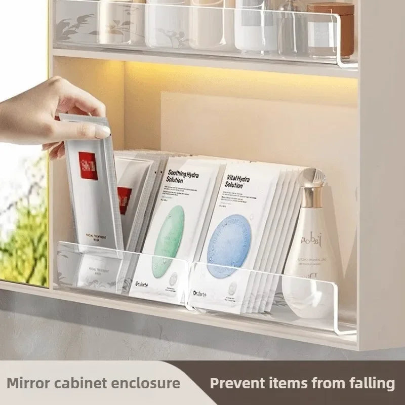 Clear acrylic shelf divider holding various skincare products inside a mirror cabinet enclosure