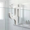 A modern, white, Y-shaped shower door towel hook mounted on a glass shower enclosure.