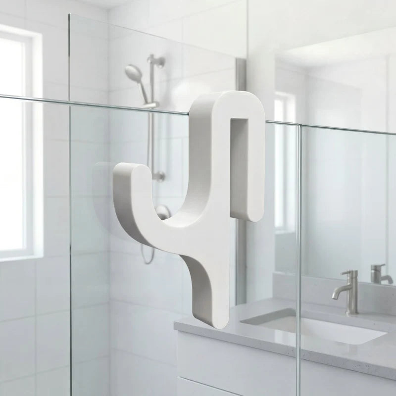 A modern, white, Y-shaped shower door towel hook mounted on a glass shower enclosure.