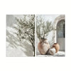 Botanical canvas wall art featuring olive branches and terracotta pots against a white background.