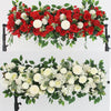 A lush floral arrangement of white roses and greenery for event decor.