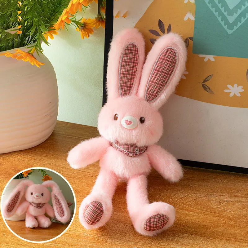 A pink giant kawaii rabbit plush toy with pink ears and a checkered collar is displayed on a wooden surface.