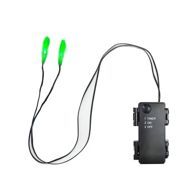 A black wire with two green LED lights and a rectangular control box for Halloween decor