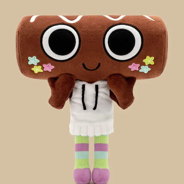 A brown plush toy with large black eyes and pink star accents, wearing a white outfit and striped legs.