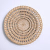 Round woven straw wall decor hanging with concentric circular patterns