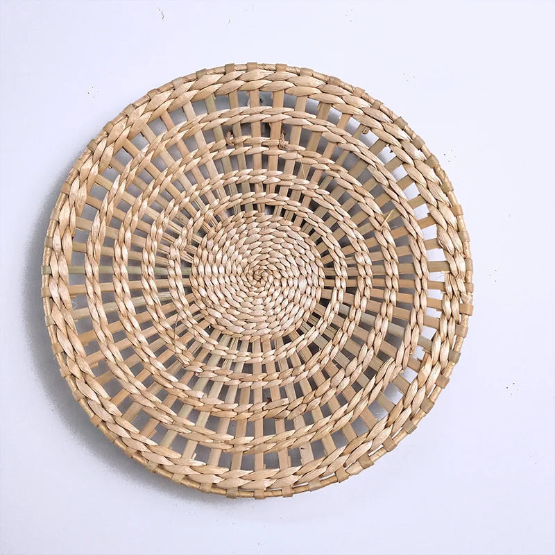 Round woven straw wall decor hanging with concentric circular patterns