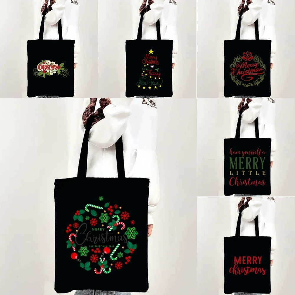 Black tote bag with a festive Christmas design featuring holly and greenery.