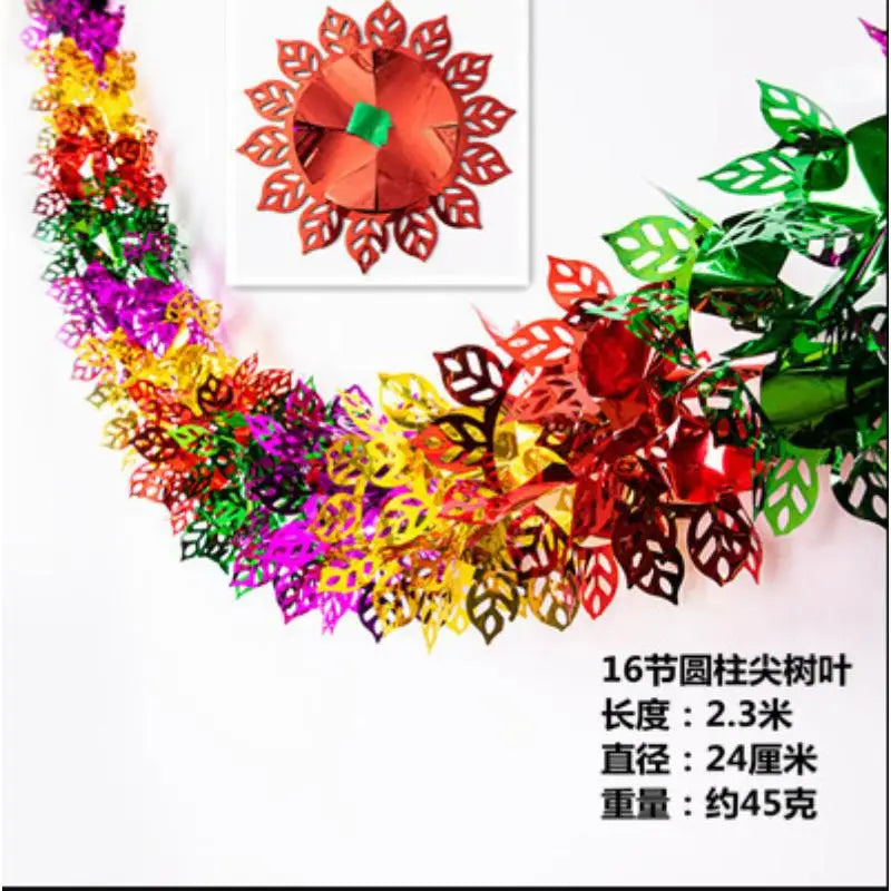 A colorful tinsel garland ribbon featuring various shades of red, green, yellow, and purple leaves and flowers.