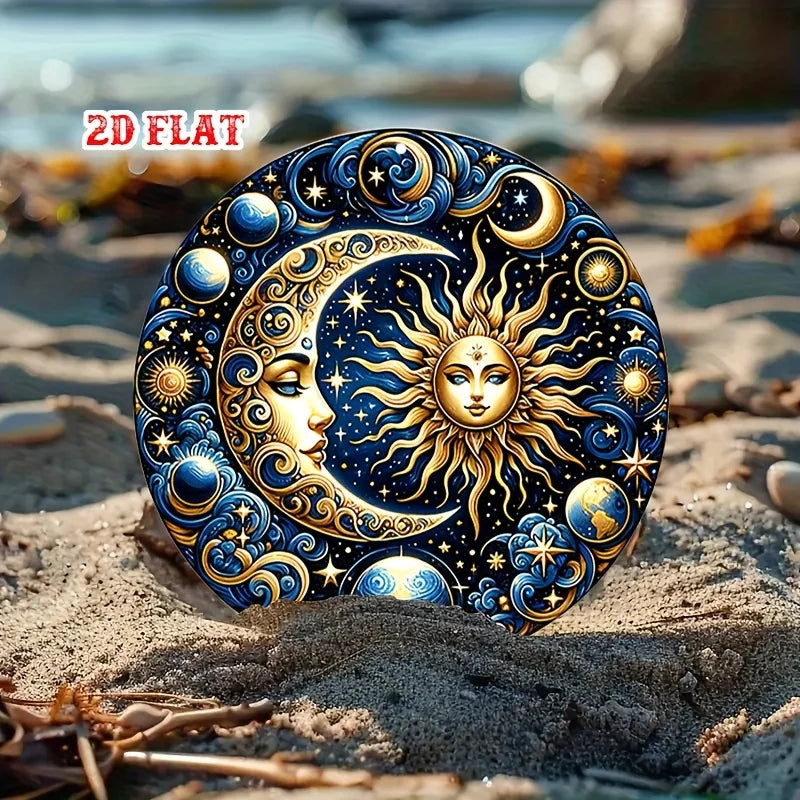 A vintage celestial sun and moon metal wall sign resting on sand, featuring intricate gold and blue designs.