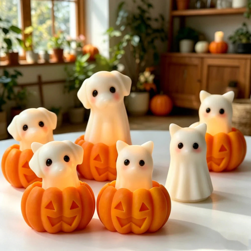 A collection of silicone candle molds shaped like cute ghosts, cats, dogs, and pumpkins in various orange and cream colors.