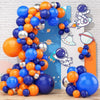 A cluster of orange, blue, and silver latex balloons arranged in a curved shape against a light background.