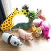 A collection of cartoon farm animal foil balloons including a giraffe, a hedgehog, a dinosaur, a pig, and a fox.