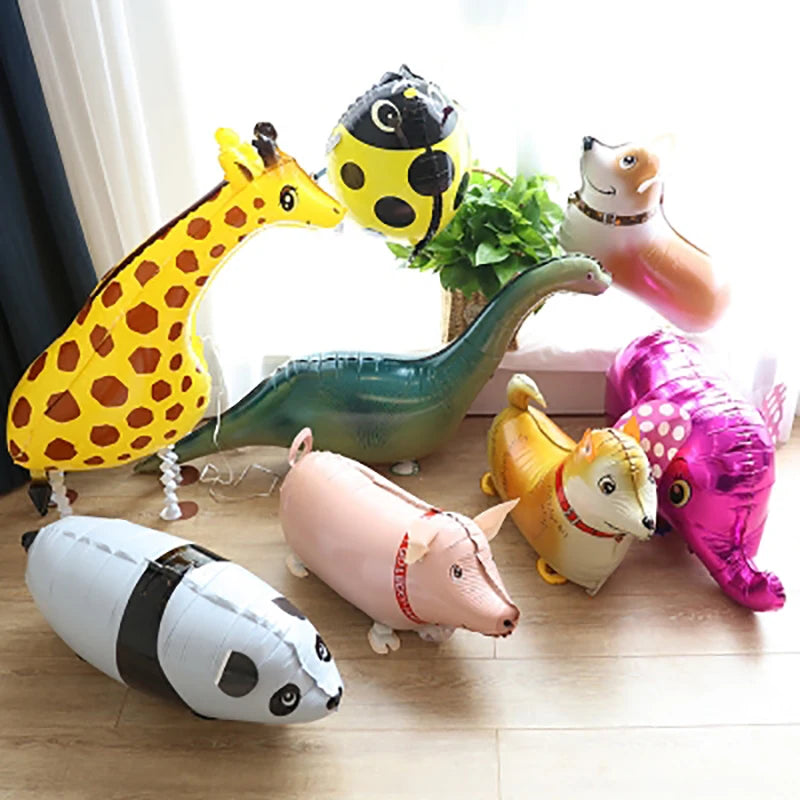 A collection of cartoon farm animal foil balloons including a giraffe, a hedgehog, a dinosaur, a pig, and a fox.