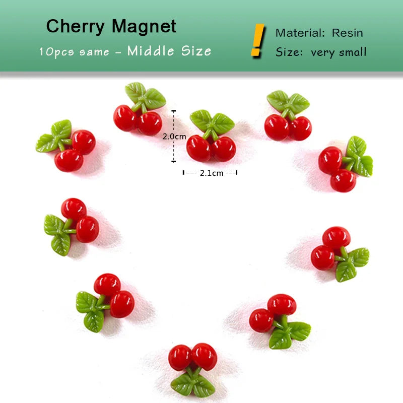 Un set de 10 pequeños imanes de cereza rojos hechos de resina con hojas verdes.