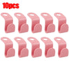 A set of 10 pink space-saving hanger connector hooks for organizing clothing.