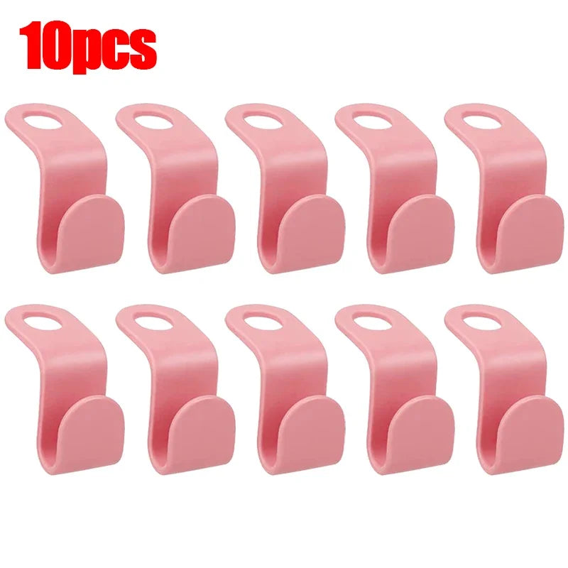 A set of 10 pink space-saving hanger connector hooks for organizing clothing.