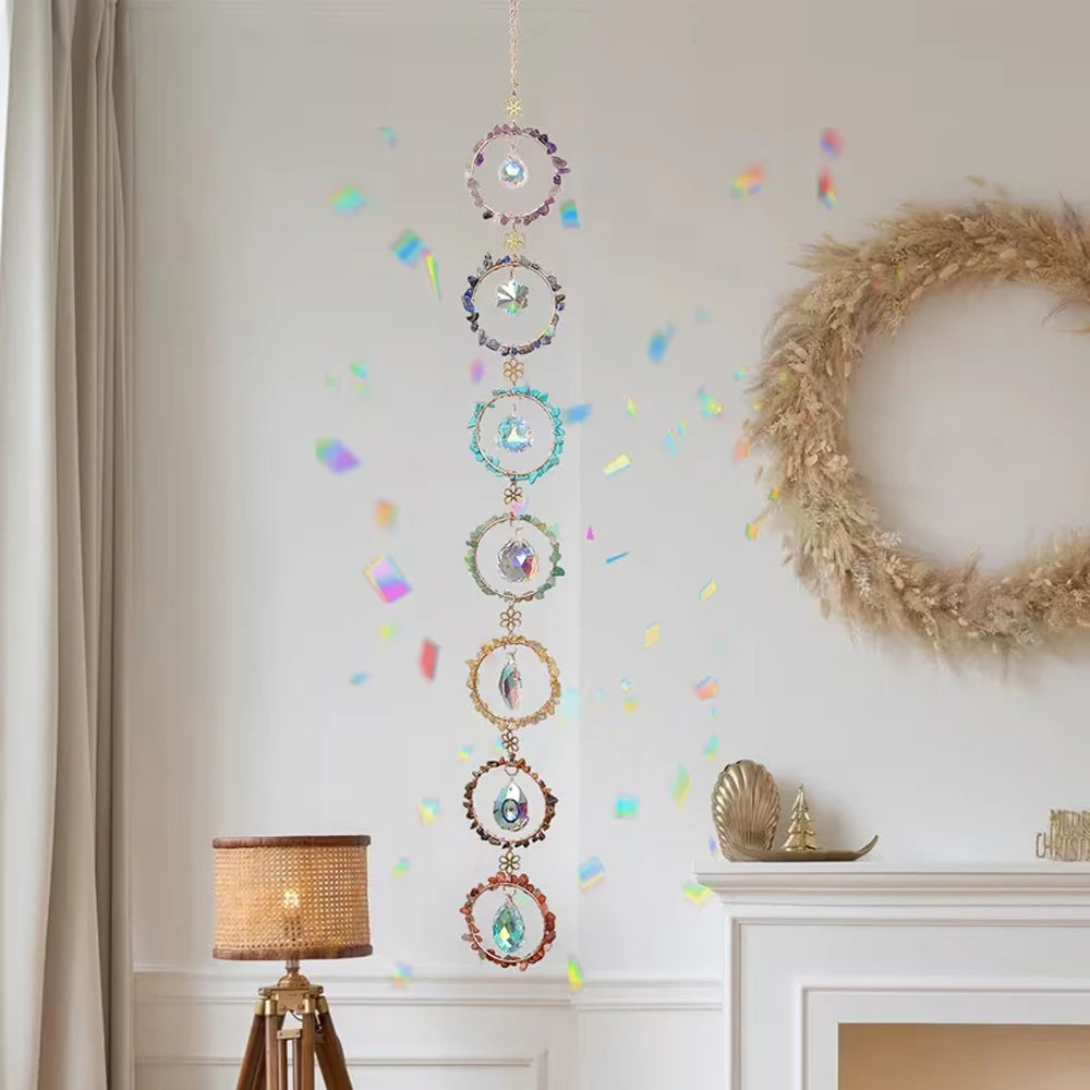 A crystal sunshine catcher set hanging on a wall, featuring multiple iridescent glass orbs and colorful confetti.