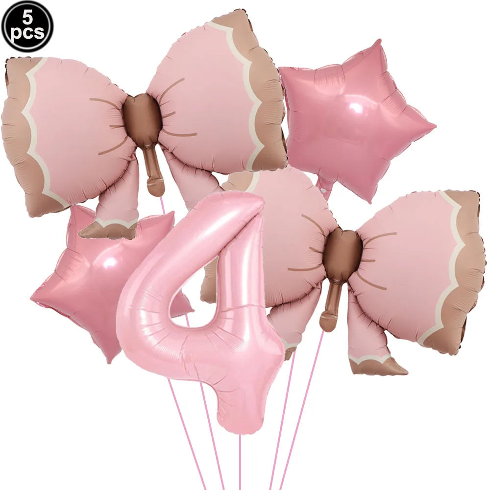 A set of pink bow disposable party tableware, including a large number four balloon.
