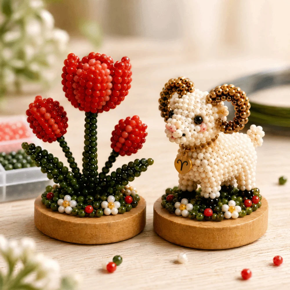 A craft kit featuring red and green glass beads arranged in floral shapes, including a white animal figure.
