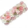 A lush floral arch panel featuring pink and white artificial roses and hydrangeas for wedding decor.