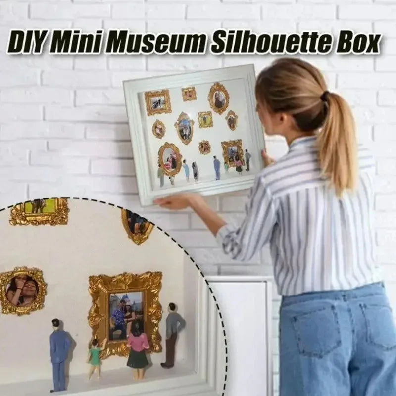 A woman is holding a framed silhouette box for a DIY mini museum project against a white brick wall.