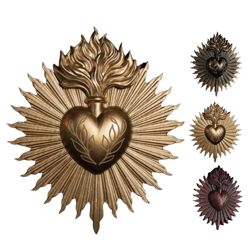 A brass wall plaque featuring a radiant sunburst design surrounding a heart motif.