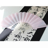 A pink glitter folding fan with transparent ribs is displayed against a dark background.
