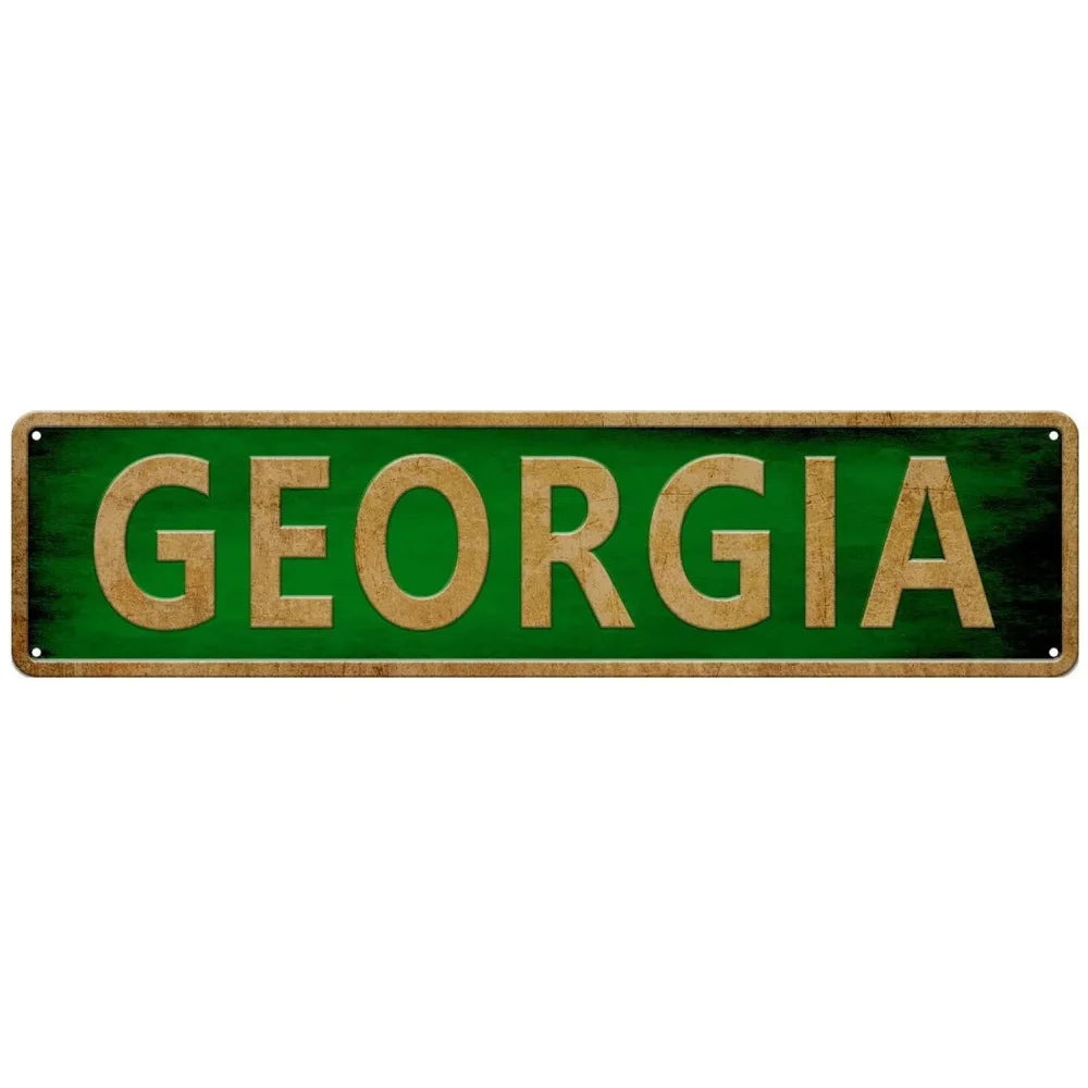 A rectangular green metal tin sign with the word GEORGIA written in gold lettering.
