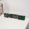 A black LED digital alarm clock displaying 20:38:56 on a white surface.
