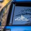 Close-up of a blue car window featuring white Masha'Allah Islamic calligraphy vinyl decal.